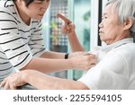 Small photo of Angry asian senior grandmother scolding woman,Aggressive old elderly people shouting pointing finger at frightened female caregiver,dissatisfaction irritated,violence aggression,mental health concept