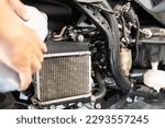Small photo of Motorcycle mechanic filling coolant,check liquid level in radiator, change the coolant in motorcycle radiator system,engine care,coolant exchange,scooter motorcycle service,maintenance concept