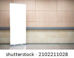 Blank roll up stand banner. Blank mockup for presentation isolated on wall background in hospital, hotel, airport.