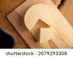 Semi-cured cheese from Brazil, beautiful Brazilian cheese arranged on light rustic wood, selective focus.