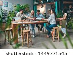 Group of young business people are working together in modern office. Creative people with laptop, tablet, smart phone, notebook. Successful hipster team in coworking. Freelancers.