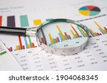 Small photo of Magnifying glass on charts graphs paper. Financial development, Banking Account, Statistics, Investment Analytic research data economy, Stock exchange trading, Business office company meeting concept.