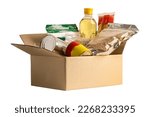 Foodstuff for donation isolated on white background with clipping path, storage and delivery. Various food, pasta, cooking oil and canned food in cardboard box.