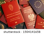 Small photo of Kingdom of Norway biometric diplomatic red passport on a colorful background of passports of various countries of the world.