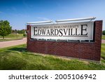 Small photo of Edwardsville, IL—July 7, 2021; Brick sign alongside road with campus buildings in background identifies location of Southern Illinois University Edwardsville.