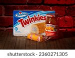 Small photo of Shiloh, IL—Sept 11, 2023; box of Twinkies with pastry in plastic wrap in front beside Orange Marmalade after Smuckers announced the purchase of Hostess