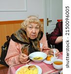 At The Canteen. An Old Woman...