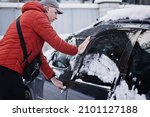 Frozen car door. Automobile car door or lock is frozen shut. Man driver trying to open frozen car door or lock