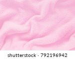 Fluffy Gentle baby pink fabric with waves and folds. Soft pastel textile texture. Folds on the soft fabric. Rose towel terry cloth.