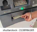 Small photo of ATM Cash withdrawal - Indian rupees in ATM. Man withdrawing the cash via ATM, business Automatic Teller Machine concept.