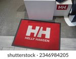 Small photo of Bordeaux , France - 08 01 2023 : hh Helly Hansen logo sign and brand text on shop carpet Norwegian producer of textiles gear for sports in ocean and mountains from Oslo