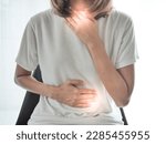 Small photo of Woman suffering heartburn and acid reflux and squeamish, health concept