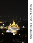 Small photo of Bangkok, Thailandland - 9 April 2023: Bangkok landmark at night. Beautiful buddhist temple golden pagoda night view of Wat Saket, the Golden Mount templet from night light in Bangkok, Thailand.