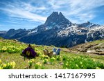 an hiker woman resting and looking the Pic du Midi Ossau in the french Pyrenees mountains
