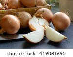 a sliced onions with a basket of onions and knife