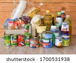 Small photo of Donations box with canned food on wooden table background / pasta canned goods and dry food non perishable with oil rice noodles spaghetti macaroni donations food : Bangkok Thailand - 5 April 2020