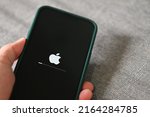 Small photo of iPhone 13 Pro with apple logo loading and installing operating system ios 15.5 on the screen close up, new ios 2022 on apple devices sub v. ios 15 for updates : Bangkok, Thailand - May 29 2022