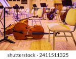 Small photo of Moscow, Russia - December, 26, 2023: During the intermission of a classical music concert. Musical instruments - cellos, bows, music stands. Moscow International House of Music-MMDM