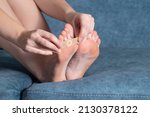 Small photo of Woman sticks a medical plaster to the plantar wart of the leg to remove dead skin and calluses