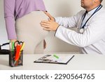 Small photo of A pregnant woman at a doctor's appointment with an obstetrician-gynecologist. Complications during pregnancy in the 3rd trimester, diabetes and arterial hypertension.