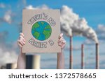 Climate change manifestation poster on an industrial fossil fuel burning 