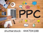 PPC - Pay Per Click concept Business team hands at work with financial reports and a laptop