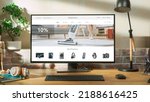 Small photo of At Home Office: Desktop Computer Standing on Adjustable Table With Page of Online Store of Electronics. e-Commerce Concept of Purchasing, Buying, Ordering Tech Devices on Website