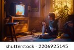 Small photo of Nostalgic Retro Concept: Young Boy Playing Old-School Eighties Arcade Video Game on a Console at Home in His Room with Period-Correct Interior. Successful Kid Passes the Level and Wins.