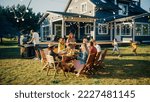 Small photo of Parents, Children and Friends Gathered at a Barbecue Dinner Table Outside a Beautiful Home. Old and Young People Have Fun, Eat and Drink. Garden Party Celebration in a Backyard.