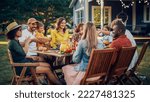 Small photo of Parents, Children, Relatives and Friends Having an Open Air Vegetarian Dinner in Their Backyard. Old and Young People Talk, Chat, Have Fun, Eat and Drink. Garden Party Celebration in a Backyard.
