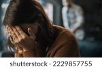 Small photo of Portrait of Crying Woman Covering Her Face with Hands, being Harrased and Bullied by Violent Partner. Couple Arguing, Fighting, Domestic Abuse, Toxic Masculinity. Rack Focus with Boyfriend Screaming