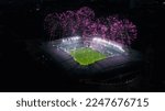 Small photo of Aerial Establishing Shot of a Whole Stadium with Soccer Final Match Starting. Teams Play, Crowd of Fans Cheer, Fireworks Launched From Top of The Arena. Football Tournament, Cup TV Broadcast.