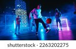 Small photo of Talented Soccer Sportsman Performing Freestyle Tricks with a Ball. Footballer Showing Off Juggling Skills. Urban City Spot with Neon Lights, Graffiti on Walls and Scenery with Skyscrapers at Night