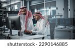 Small photo of Two Young Saudi Software Engineers Use Desktop Computer to Discuss a Technological Project in a Modern Industrial Office. Arab Scientists Work in Research and Development Center