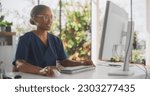 Small photo of African Healthcare Nurse Using Desktop Computer for Day-to-Day Hospital Operations. Beautiful Young Clinic Professional Using PC for Online Medical Work in Modern Office in Public Health Care Facility