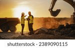 Small photo of Cinematic Golden Hour Shot Of Construction Site: Caucasian Male Civil Engineer And Hispanic Female Urban Planner Talking, Using Tablet. Trucks, Excavators, Loaders Working To Build New Apartment Block