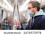 Close up of man holds a handrail in public transportsubway through a napkin, to protect yourself from contact with viruses, germs during a coronavirus pandemic, covid-19. Quarantine concept