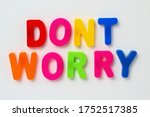 Text DONT WORRY made by magnetic letters on a white wooden background. Business Success Motivation