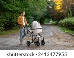 A young father walks with a...