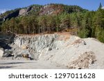 Small photo of Excavator at small quarry in Norway, Scandinavia, mining construction aggregate and riprap