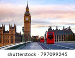 Small photo of London morning traffic scene with red Double Decker buses move along the Westminster Bridge with Palace of Westminster Elizabeth Tower aka Big Ben in background