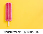 Strawberry popsicle on yellow background
