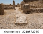 Small photo of Carved marble architectural detail with a phallic symbol on the ground of the ancient Roman archaeological site of Sbeitla or Sufetula, Tunisia.