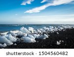 Diamond beach, Iceland. Tourist popular attraction/destination near Jokulsarlon Glacier Lagoon. Pieces of ice from glacier laying on black sandy beach.