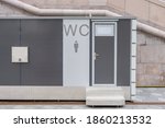 modern public toilet exterior outdoor. Modern Toilet metal building, outdoor, day time. Front view of modern restroom. Facade of outdoor lavatory with men women WC sign