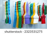 Small photo of Brushes hang on shelf. Color coded hygiene glazing brushes and detail brushes for food processing and manufacturing. Cleaning tool for food safety in food and beverage industry. Durable cleaning brush