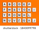 Letters of the english alphabet, a homemade wooden tile with letters on a orange background.