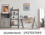 Background of minimal home office workplace in modern apartment decorated by plants and abstract art, copy space