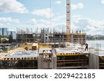 Wide angle view at construction site with unfinished residential buildings against blue sky, copy space