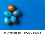 Blue and golden modern easter eggs on a white background. Top view. Easter concept. Isolated.